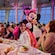 Minnie Mouse greeting Guests seated at a table in Hollywood Spotlight Club on the Disney Adventure cruise ship